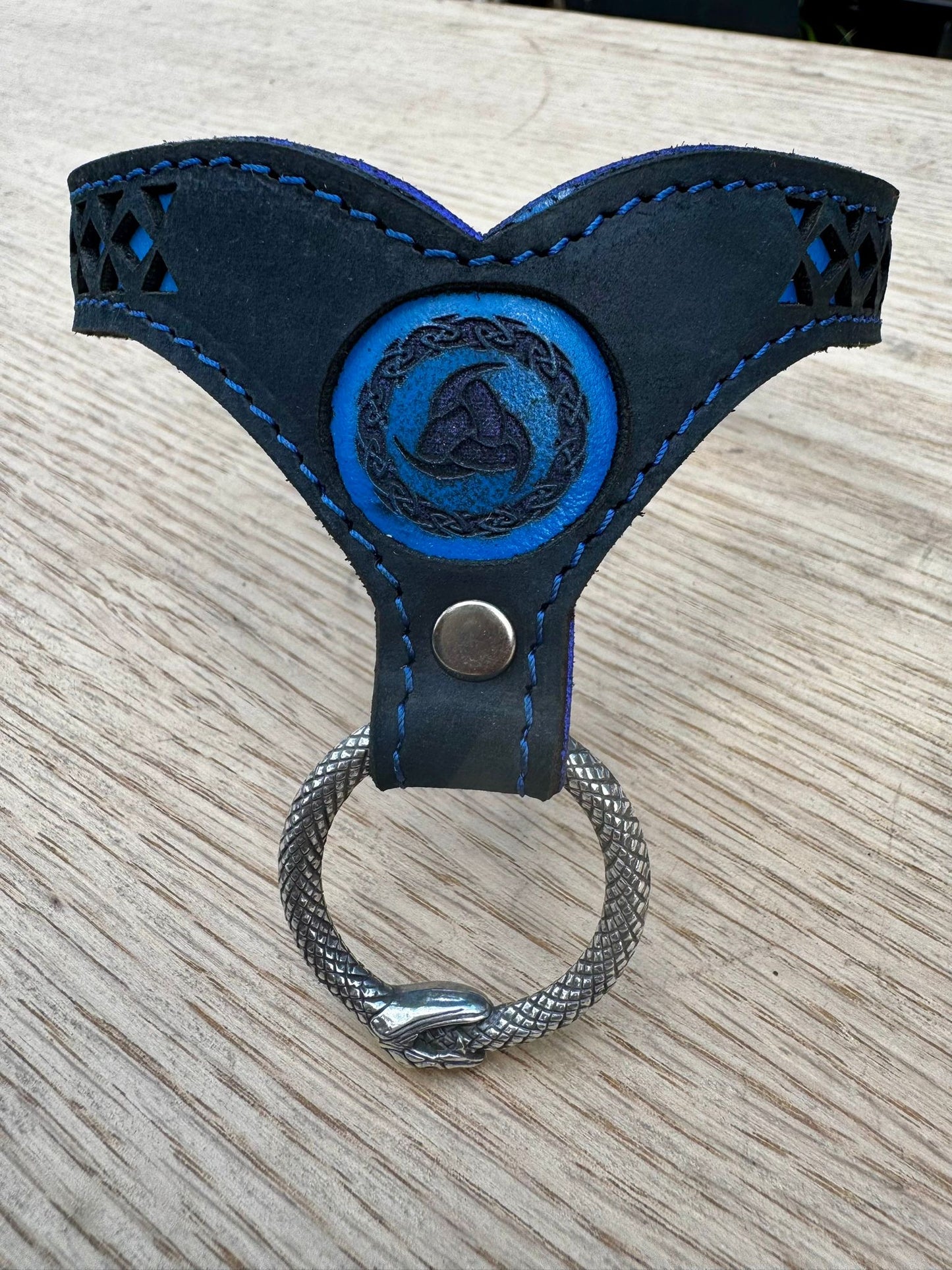 Nordic collar-  blue backing with blue stitching, black leather. Ouroboros ring