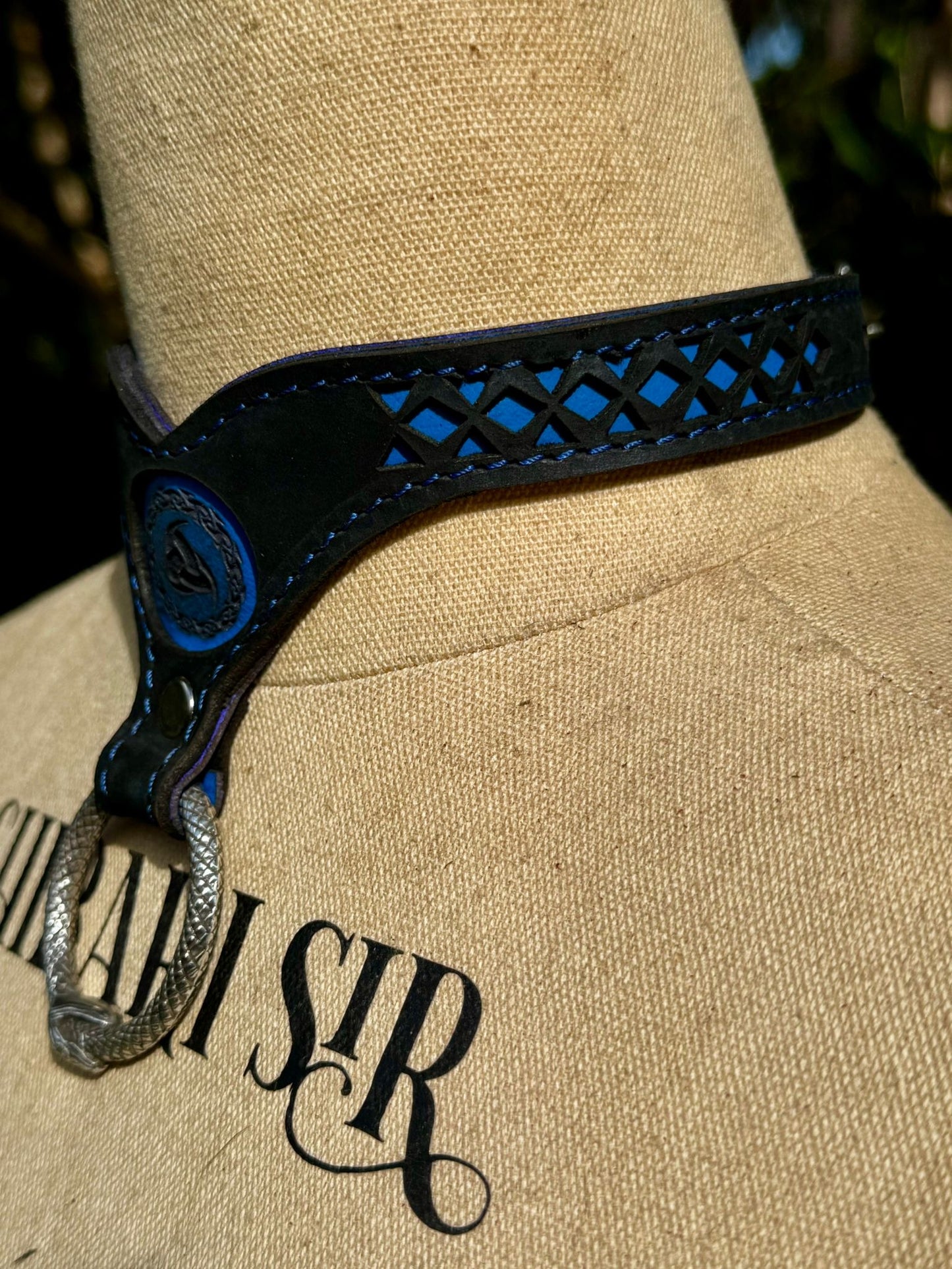 Nordic collar-  blue backing with blue stitching, black leather. Ouroboros ring