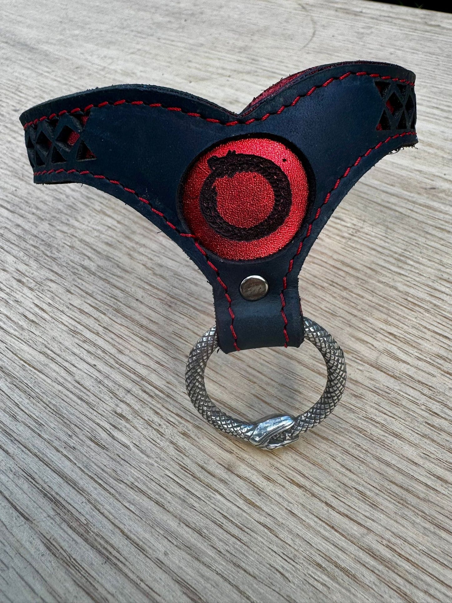 Ouroboros collar-  crimson metallic red with red stitching, black leather. Ouroboros ring