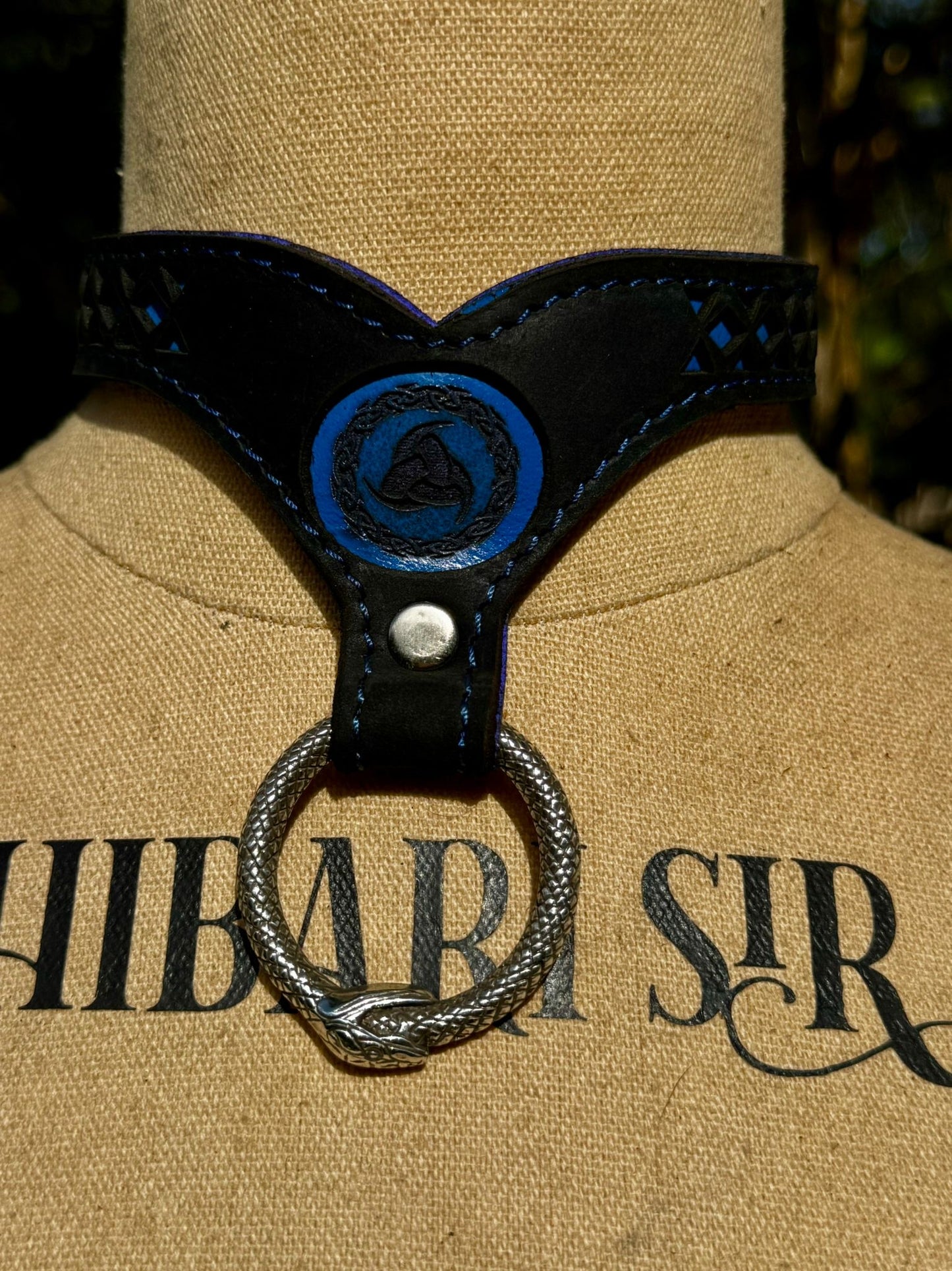 Nordic collar-  blue backing with blue stitching, black leather. Ouroboros ring
