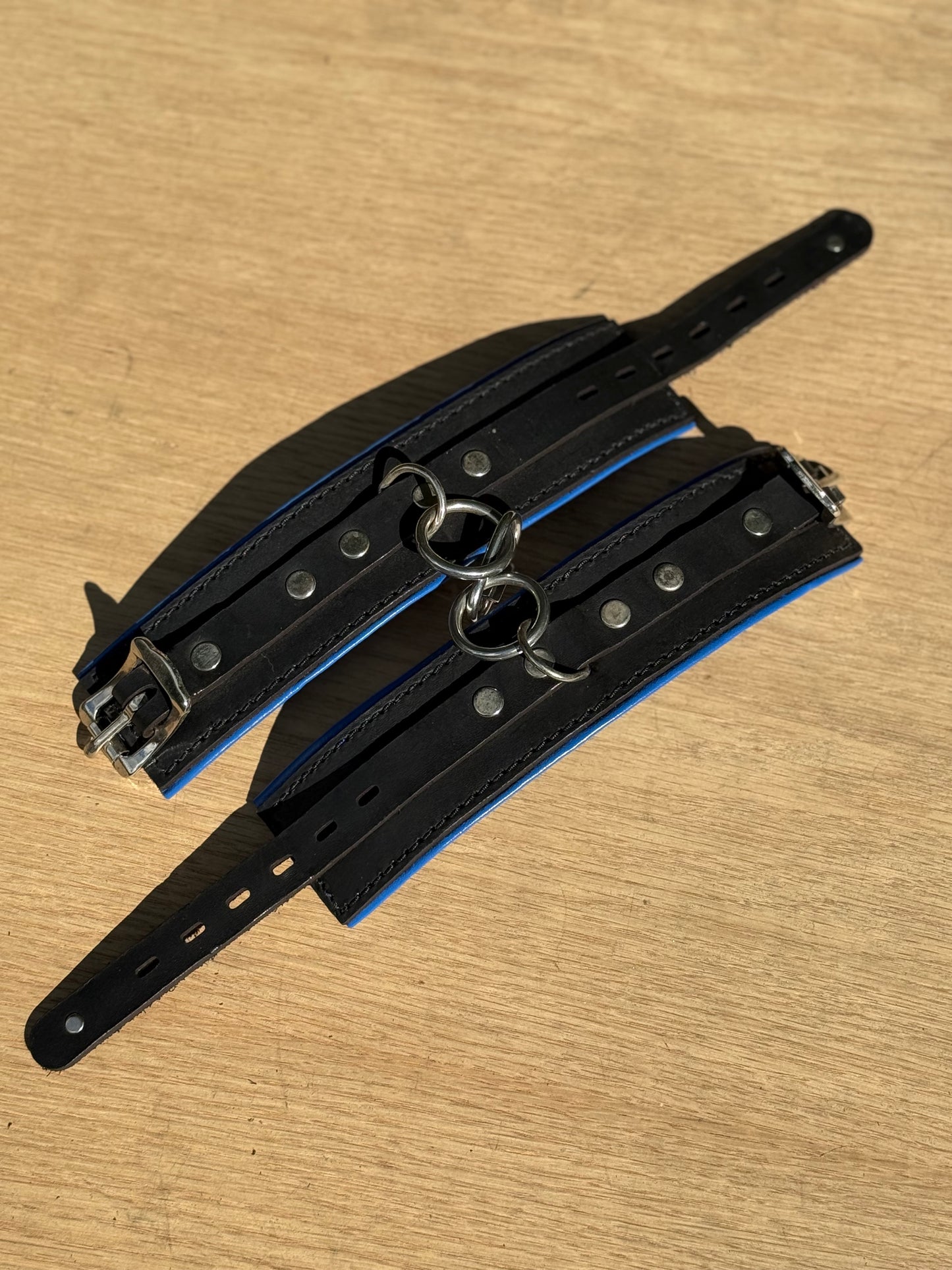 Solid single strap blue padded kink cuffs ( a pair ) on sale. Reduced to $115