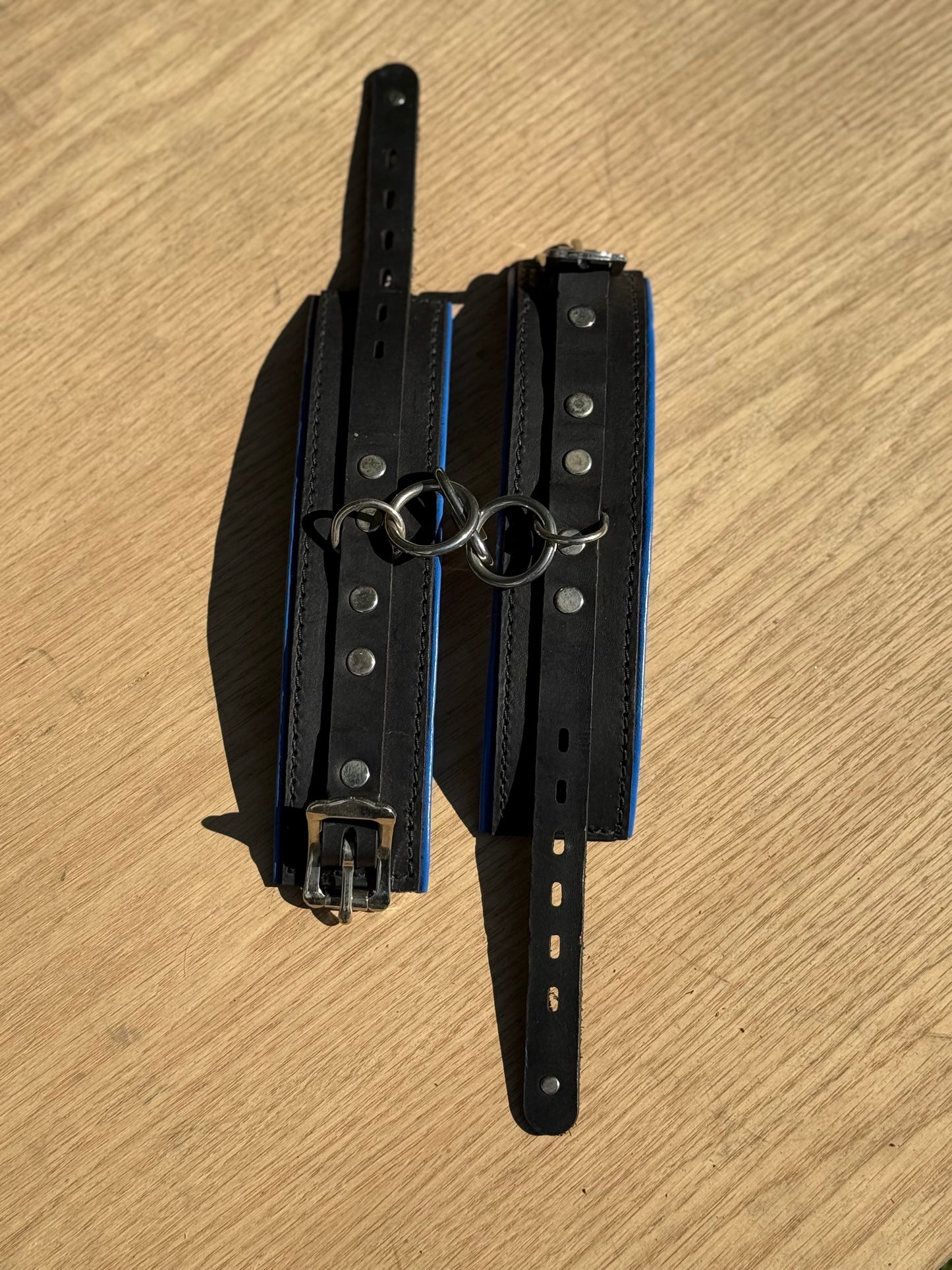 Solid single strap blue padded kink cuffs ( a pair ) on sale. Reduced to $115