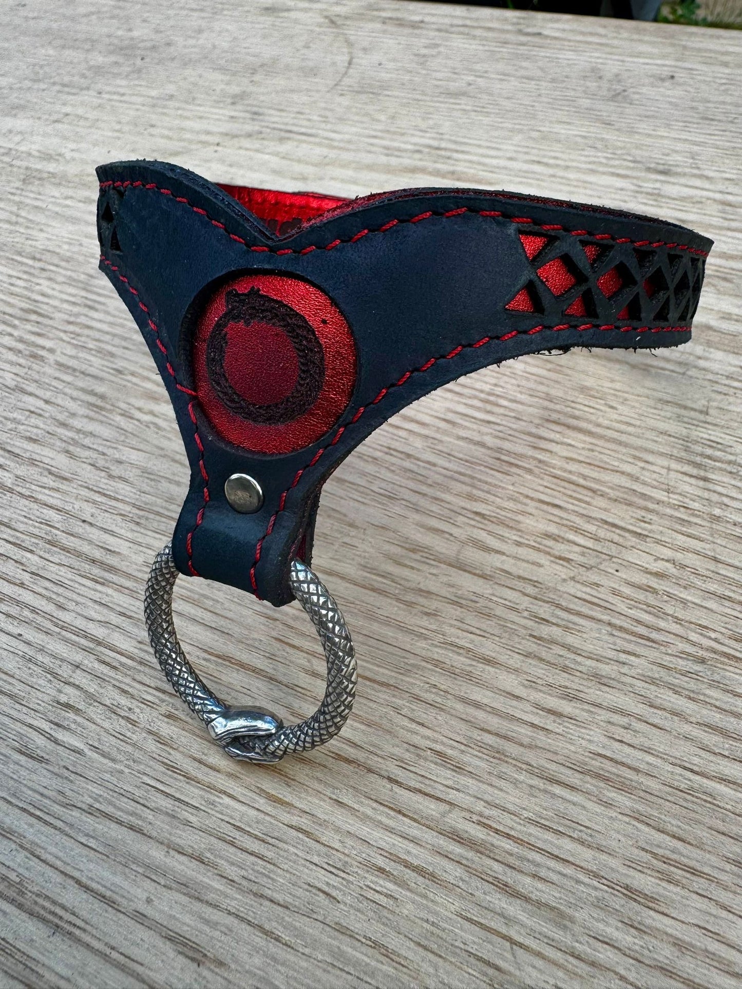 Ouroboros collar-  crimson metallic red with red stitching, black leather. Ouroboros ring