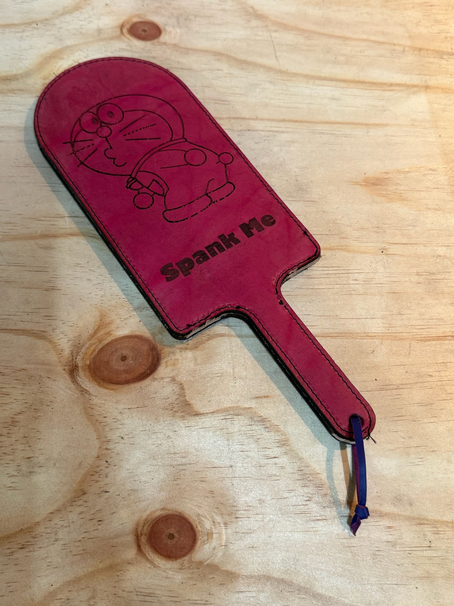 Pink doramon paddle with metalic rainbow backing