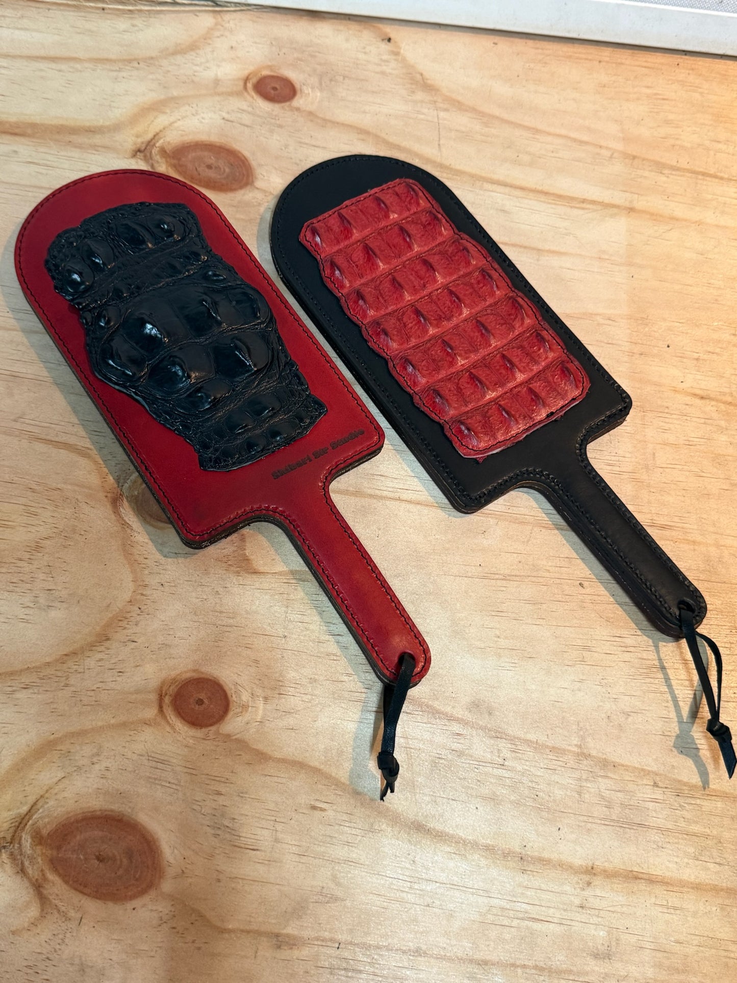 Red paddle with black crocodile