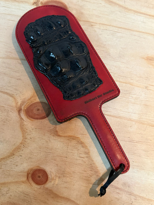 Red paddle with black crocodile