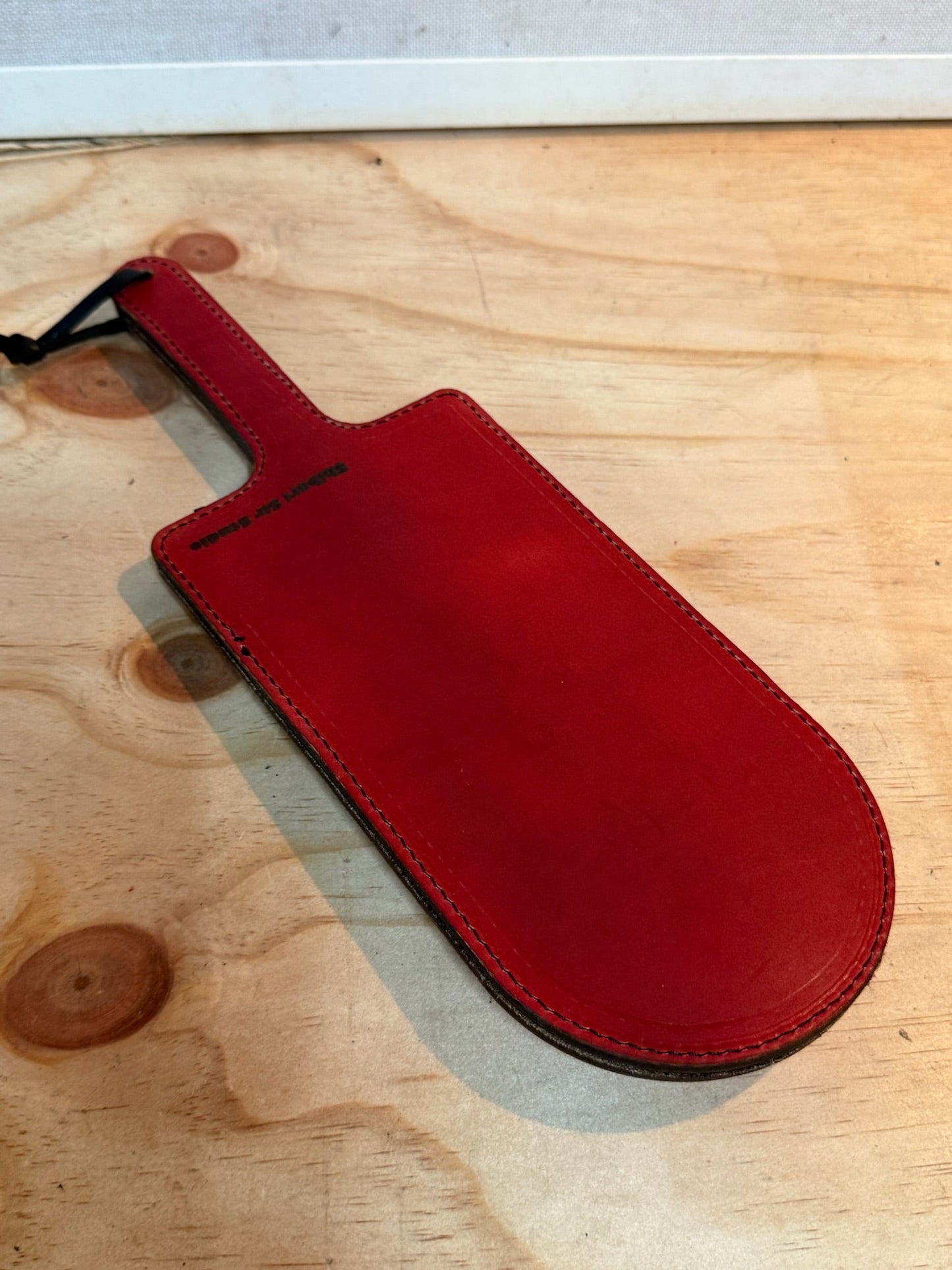 Red paddle with black crocodile